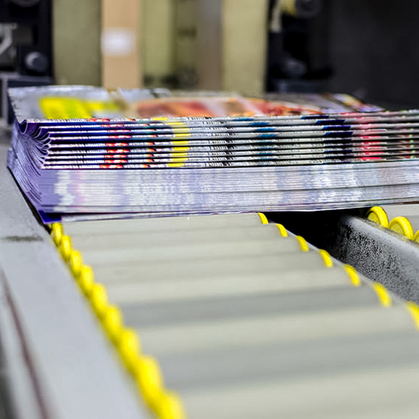 bound newsletters on the production conveyor